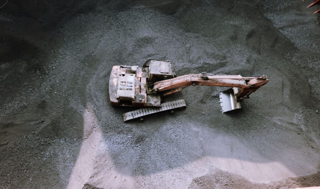 Aerial view of an excavator working at a construction site in Visakhapatnam, India.